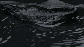 Slow motion water surface texture splashes, waves and ripples with black stone - Powered by Shutterstock - Get 15% off with code: PIKWIZARD15