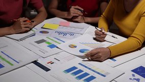 Financial analysis teamwork in business collaboration. Business professionals collaborate on financial reports and data analysis. Strategy and planning. Executive focus on charts, graphs, and figures. - Powered by Shutterstock - Get 15% off with code: PIKWIZARD15