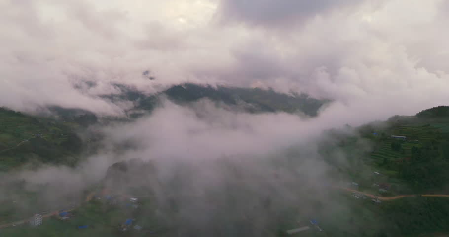 Clouds above Nepali Village in Dolakha landscape captured by drone and serene greenery landscape view mystically situated in heavenly tourism place Nepal