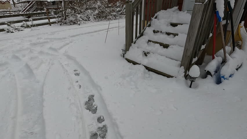 backyard and back stairs covered with snow after the snow storm in January