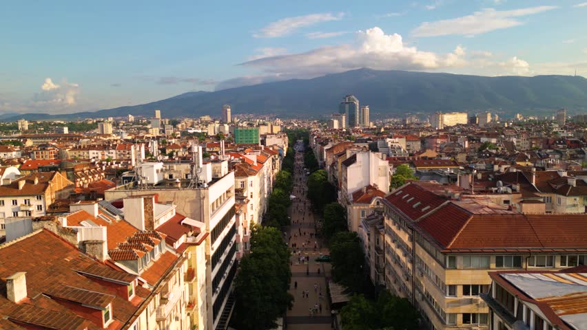 Aerial footage of the city center of Sofia Bulgaria. Main pedestrian street, City Court, National Palace of Culture, Vitoshka boulevard. Sunny view golden hour of european capital architecture.
