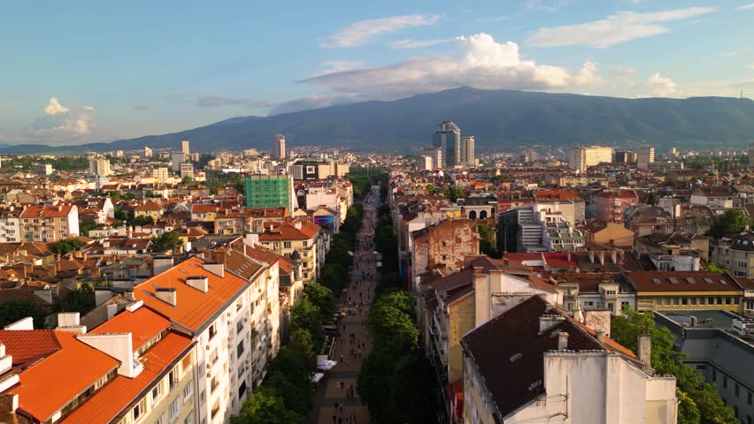 Aerial footage of the city center of Sofia Bulgaria. Main pedestrian street, City Court, National Palace of Culture, Vitoshka boulevard. Sunny view golden hour of european capital architecture.