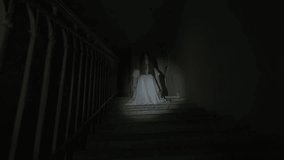 Creepy ghost woman in white dress and scary makeup alone on staircase in dark haunted house lighted by flashlight. Halloween horror advertisement concept. - Powered by Shutterstock - Get 15% off with code: PIKWIZARD15