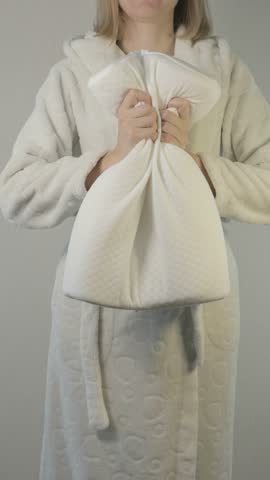 Vertical orientation footage of a woman with memory foam orthopedic pillow for healthy comfort sleeping.