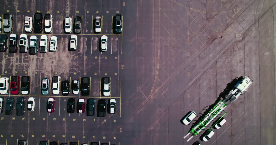 Top down of stingers car hauler double deck trailer loading with new cars for dealership auto industry. Near Chicago.