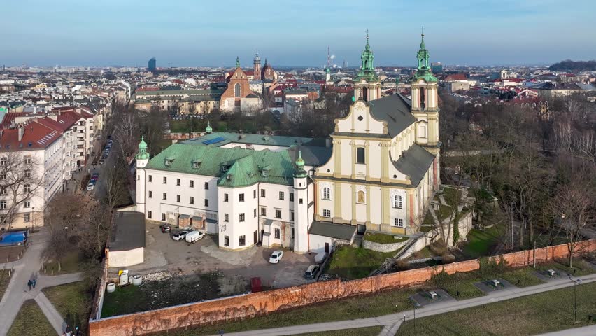 Skalka, church na Skalce in Krakow, Poland. St. Stanislaus church and Paulinite monastery. Burial place of distinguished Poles. Aerial view. Winter, sunset light. Promenade with walking people