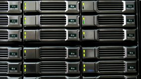 Detailed view of 4TB hard drives in a server rack, glowing green lights show they're online. Ideal for illustrating data storage, cloud services, and IT systems - Powered by Shutterstock - Get 15% off with code: PIKWIZARD15