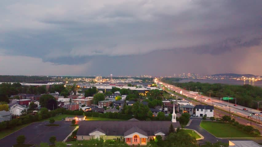 Flashes Of Lightning On Stormy Cloudy Sky Over The Cityscape Of Montreal, Canada. Aerial Shot