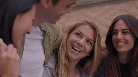 Diverse group of joyful generation z friends having fun standing embracing on city street together. Happy young university people gathered laughing hugging outdoors. Concept of student community - Powered by Shutterstock - Get 15% off with code: PIKWIZARD15