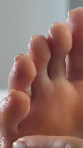 Female masseur hand massages woman feet. Thai massage concept. Treatment in health spa promotes relaxation. Soft skin and soothing touch enhance experience. Body care and healthcare focus on wellbeing