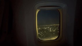 plane is descending in the evening,city lights night view of jakarta, Indonesia is seen from the airplane window or porthole. - Powered by Shutterstock - Get 15% off with code: PIKWIZARD15