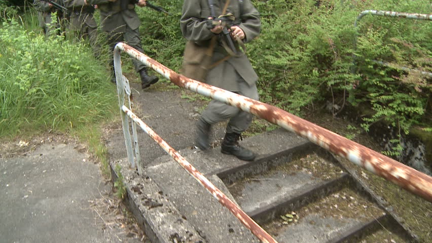 Soldiers running through forest, slow motion