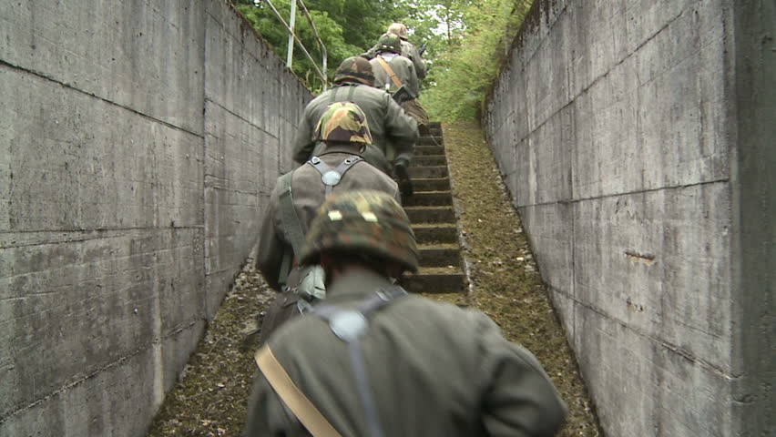 Soldiers running up stairs, slow motion 