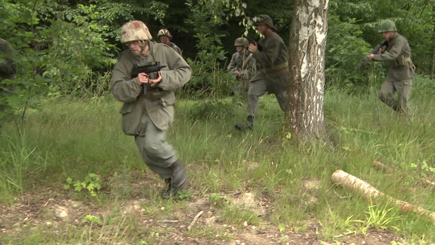 Soldiers running in field - slow motion shot