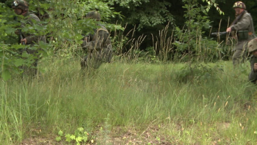 Soldiers running over field - slow motion shot