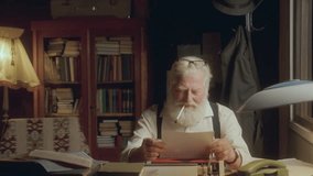 Elderly writer smoking cigarette, taking notes and reading over his manuscript, then crumpling and discarding paper in frustration as working at desk in cozy study - Powered by Shutterstock - Get 15% off with code: PIKWIZARD15