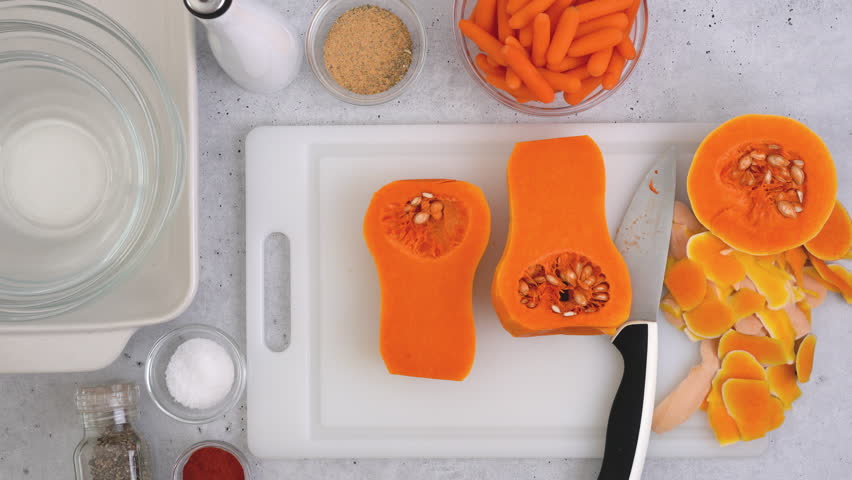 Butternut squash soup recipe, preparation process.Woman hands peeling squash, flat lay