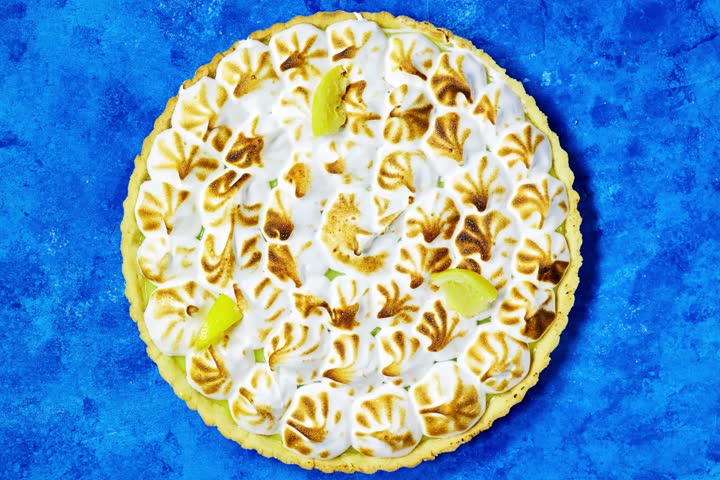 Traditional french lemon Meringue tart on blue grunge background
