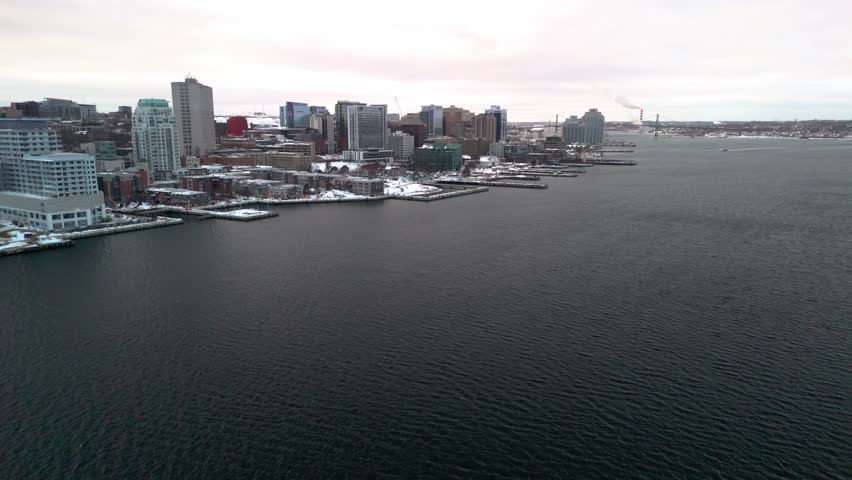 An Aerial Shot Of Halifax In Winter, With Snow-Laden Roofs And Roads Treacherous With Ice, Offering A Stunning Yet Harsh View Of The Season.