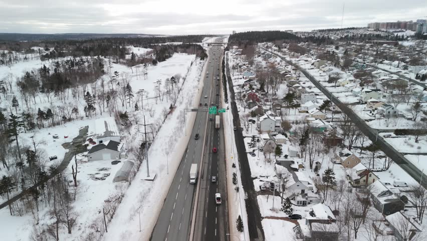 An Icy Winter Scene From Above As Cars And Trucks Travel On The Slippery Roads Of A Multi-Lane Highway In Halifax, Nova Scotia. Aerial Winter View Of Halifax Highway Trucks And Cars On Icy Roads.