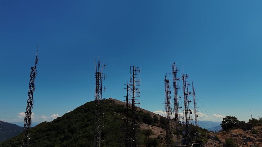 Camera panning over mountaintop telecommunication towers