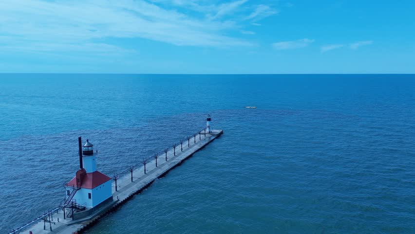 Aerial hold shot showing both lighthouses at St Johns, Michigan, looking out over Lake Michigan