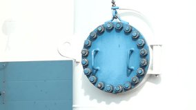 Sugulda, Latvia - August 10, 2024 - Close-up of a large blue industrial valve cover with bolts on a white and blue structure.
 - Powered by Shutterstock - Get 15% off with code: PIKWIZARD15