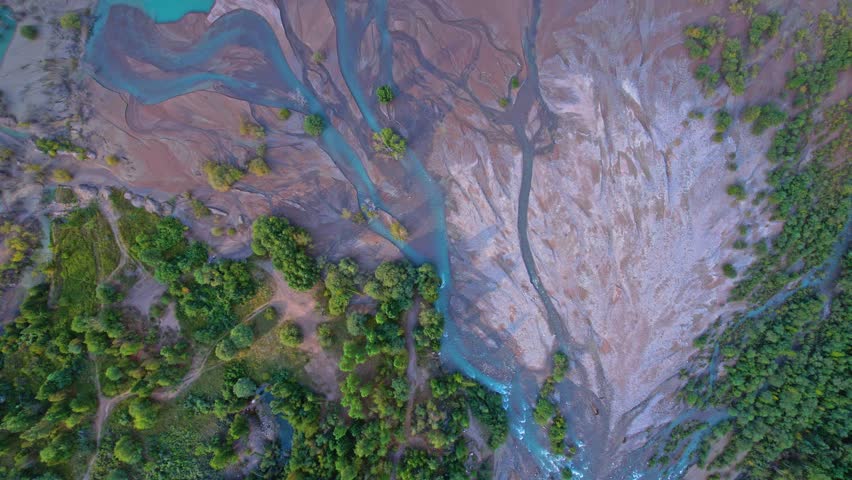 Lake Issyk, Almaty, Kazakhstan. Very beautiful landscape. Mountain lake with turquoise water against a background of mountains and trees with green grass
