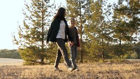 Mother's Day. Mom walks with her child in the park during sunset. Mother and son walk among the trees in an autumn park. Concept of a happy family. Communicating with a teenager. - Powered by Shutterstock - Get 15% off with code: PIKWIZARD15