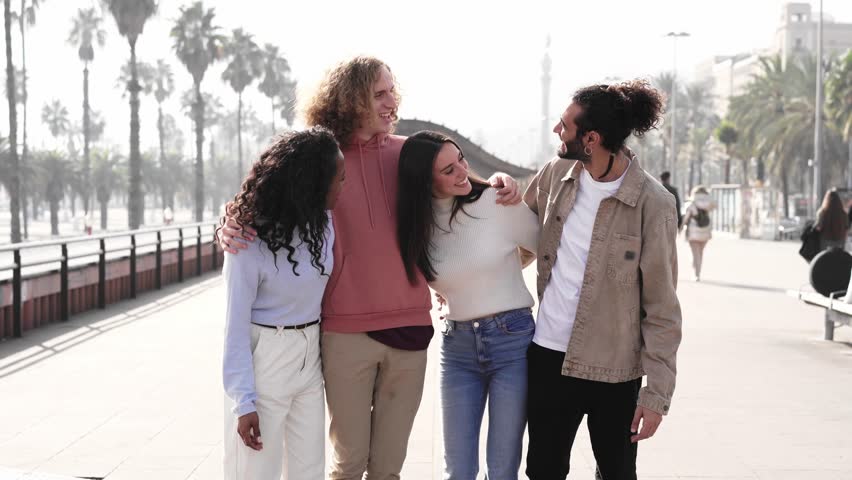Group Of Friends Crossing Urban Street. Happy people walking hugging together. High quality photo