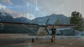 Man standing by small airplane with data processing animation over mountains. Aviation, technology, pilot, small business, innovation, outdoors - Powered by Shutterstock - Get 15% off with code: PIKWIZARD15
