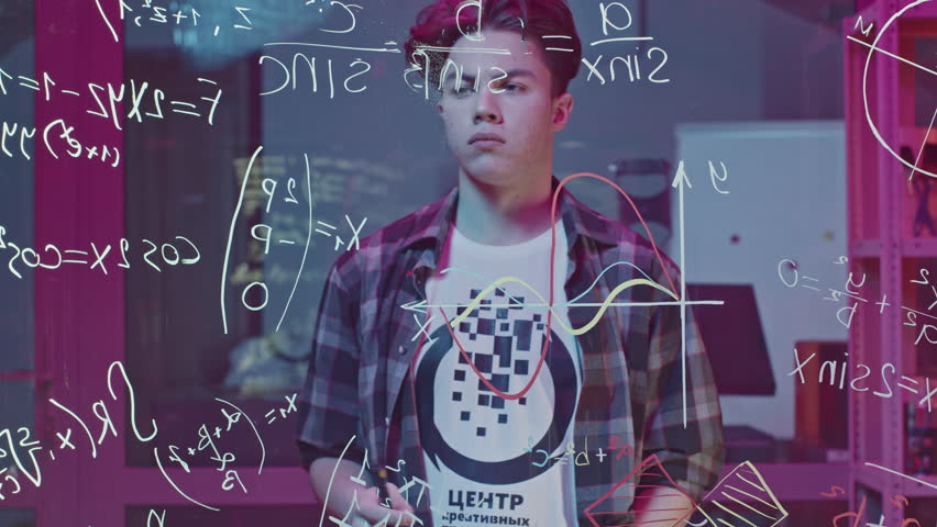 Man solves equations on transparent board. Media. Young man solves equations in closed laboratory. Man solves mathematical equations on blackboard with marker - Powered by Shutterstock - Get 15% off with code: PIKWIZARD15