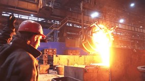 A skilled blacksmith is diligently working with molten metal inside a bustling steel factory. Stock Clip - Powered by Shutterstock - Get 15% off with code: PIKWIZARD15