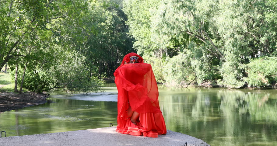 Oriental dance - beautiful young woman in red dance costume