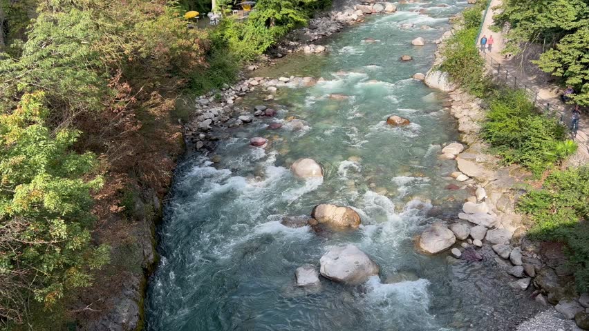 Forests and ancient buildings along the Passirio River, in the city of Merano, Italy