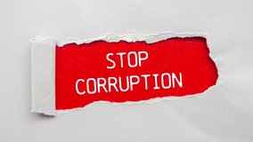 Stop corruption message writing on ripped gray torn paper on red background. Conceptual stop corruption symbol. - Powered by Shutterstock - Get 15% off with code: PIKWIZARD15