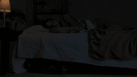 Woman sleeping in bed in dark apartment room, monster hiding under bed. Storm and lightning flash lights outside. Halloween horror concept. - Powered by Shutterstock - Get 15% off with code: PIKWIZARD15
