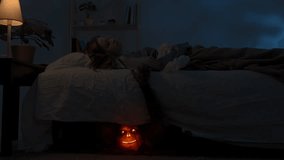 Woman sleeping in bed in dark apartment room, monster with scary face hiding under bed, creepy hand crawling out and touching girl. Halloween horror concept. - Powered by Shutterstock - Get 15% off with code: PIKWIZARD15