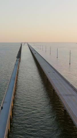 Aerial shot of the Seven Mile Bridge in Florida at sunrise. The bridge connects the Florida Keys on the way to Key West. Vertical video.