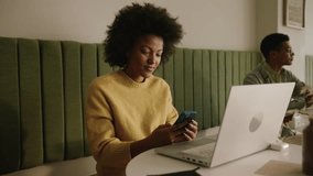 African American business woman typing on her cell phone - Powered by Shutterstock - Get 15% off with code: PIKWIZARD15