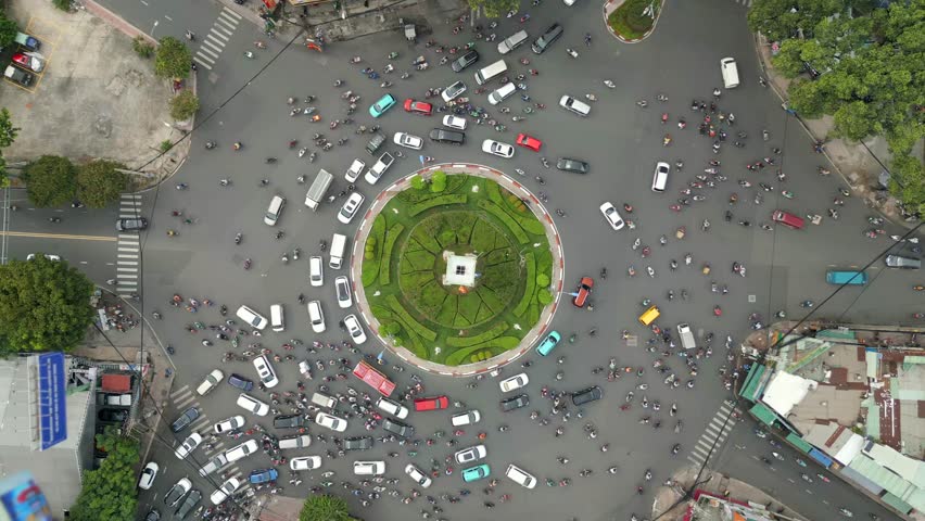 Aerial view of morning traffic at a roundabout in Ho Chi Minh City at a fast pace, Vietnam