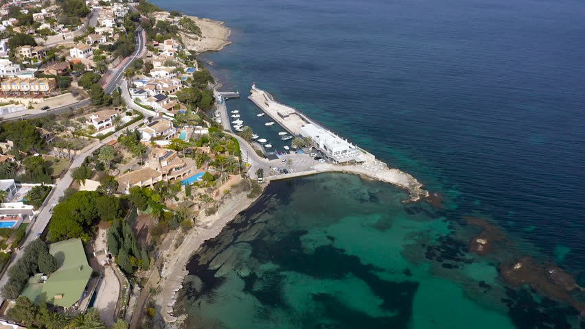 Aerial view of the little beach of Cala Fustera, and Les Bassetes port in Benissa coast, Mediterranean Sea, Spain.