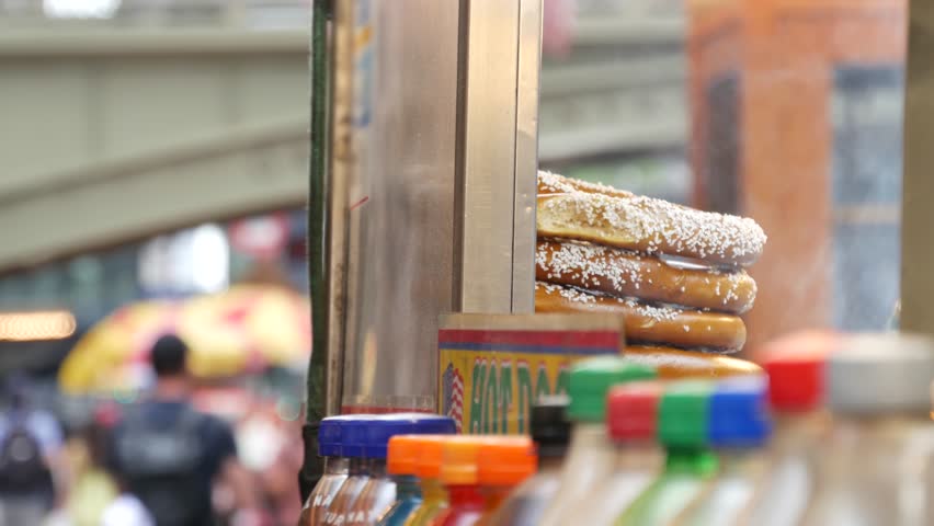 New York City life, Manhattan Midtown 42 street. Fast food hot dog, street food kiosk. Defocused people pedestrian near Grand Central Terminal Station, Pershing Square Bridge USA. Precel, hotdog to go