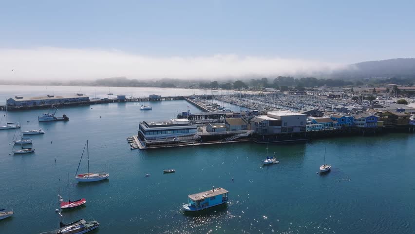Beautiful aerial view of the Monterey town in California with many yachts docked by the wharf.
