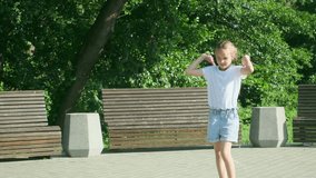Preteen girl with jumping rope in park. Portrait of happy caucasian kid jumping with skipping rope outdoors in summer park - Powered by Shutterstock - Get 15% off with code: PIKWIZARD15