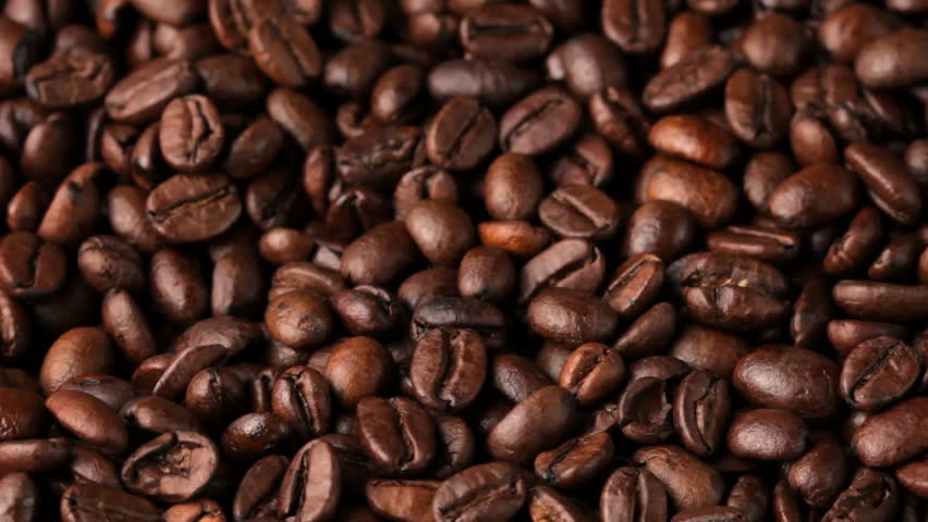 Close up of rotating coffee bean background, shot in HD video