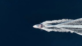 Aerial overhead view of a RIB Boat with outboard engine crossing the blue ocean with speed - Powered by Shutterstock - Get 15% off with code: PIKWIZARD15