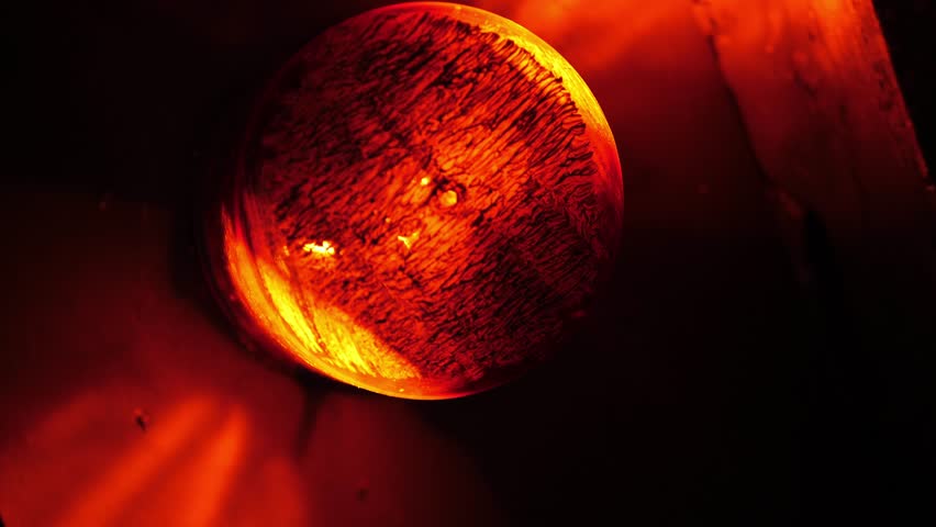 Close-up of a rotating red emergency siren lamp on the wall of a dark tunnel. A bomb shelter, an emergency signal on the wall during an air raid.