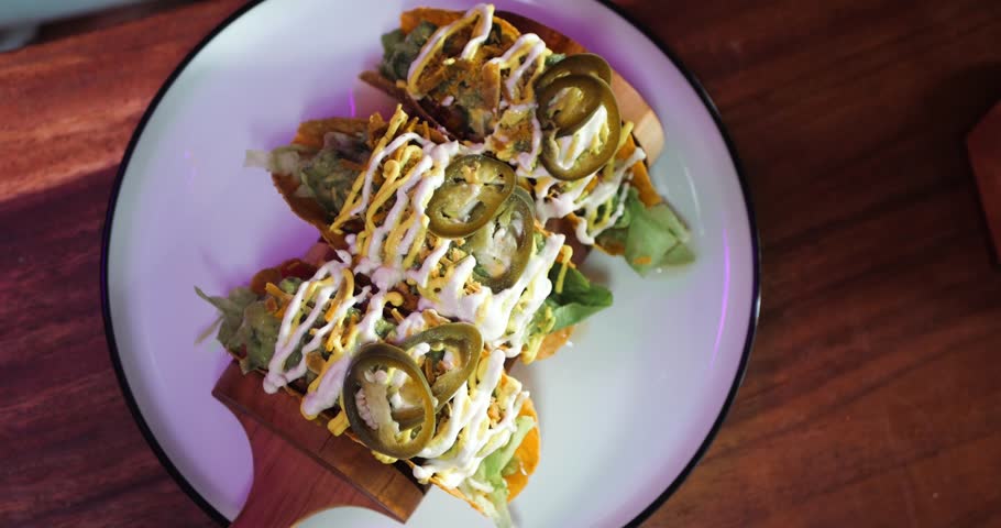 A Trio of Crispy Taco Shells Loaded With Walnut Meat, Iceberg Lettuce, Salsa, Cashew Sour Cream, and Guacamole. A Feast of Flavours and Textures