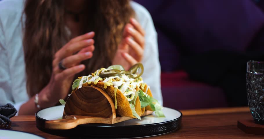 Hungry Woman Rubs Her Hands Together as She Waits to Eat Her Food.